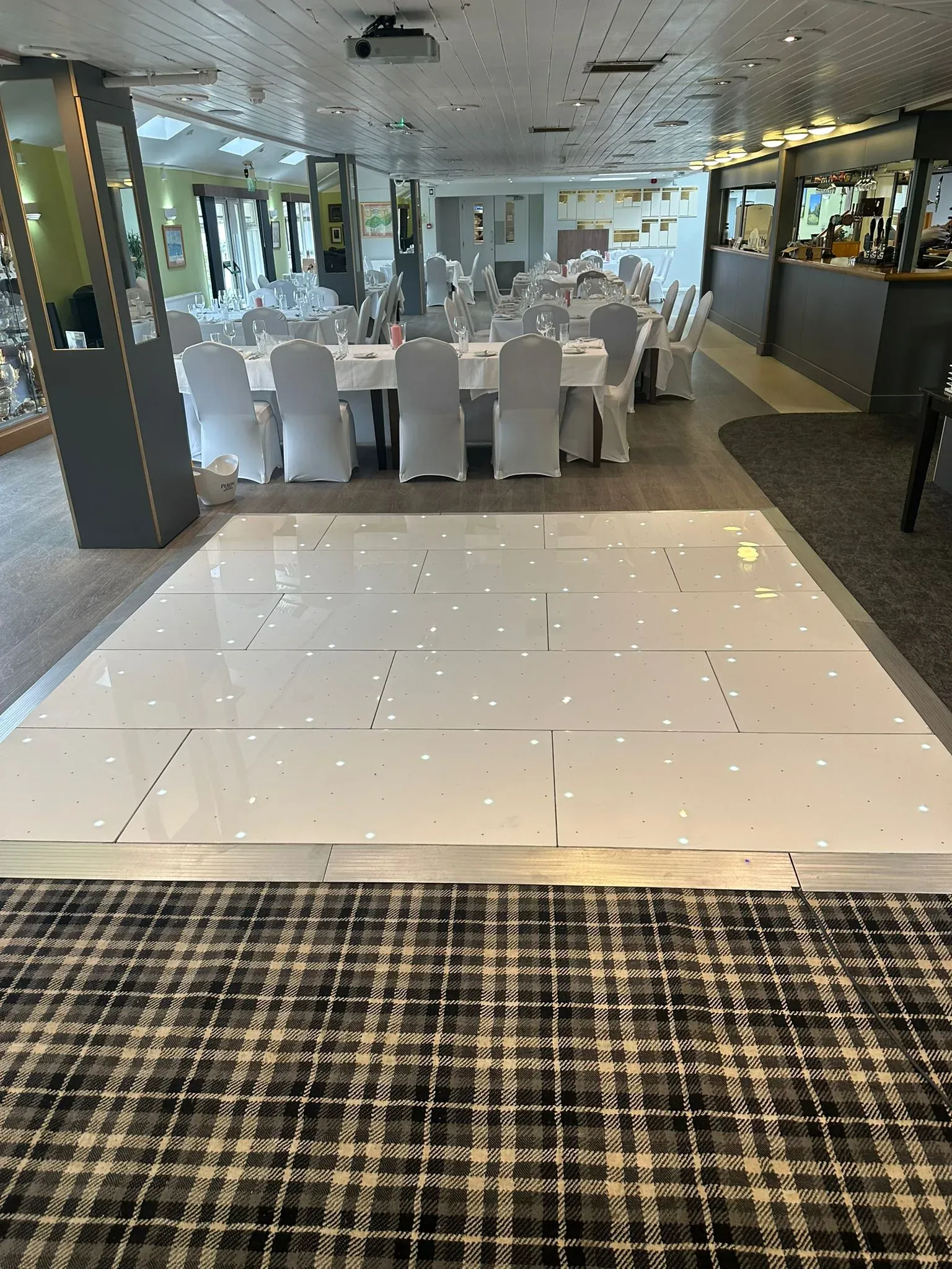 White LED starlit dance floor in a spacious wedding hall