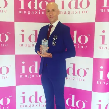 Award-winning Disco Entertainers team holding I Do Magazine award
